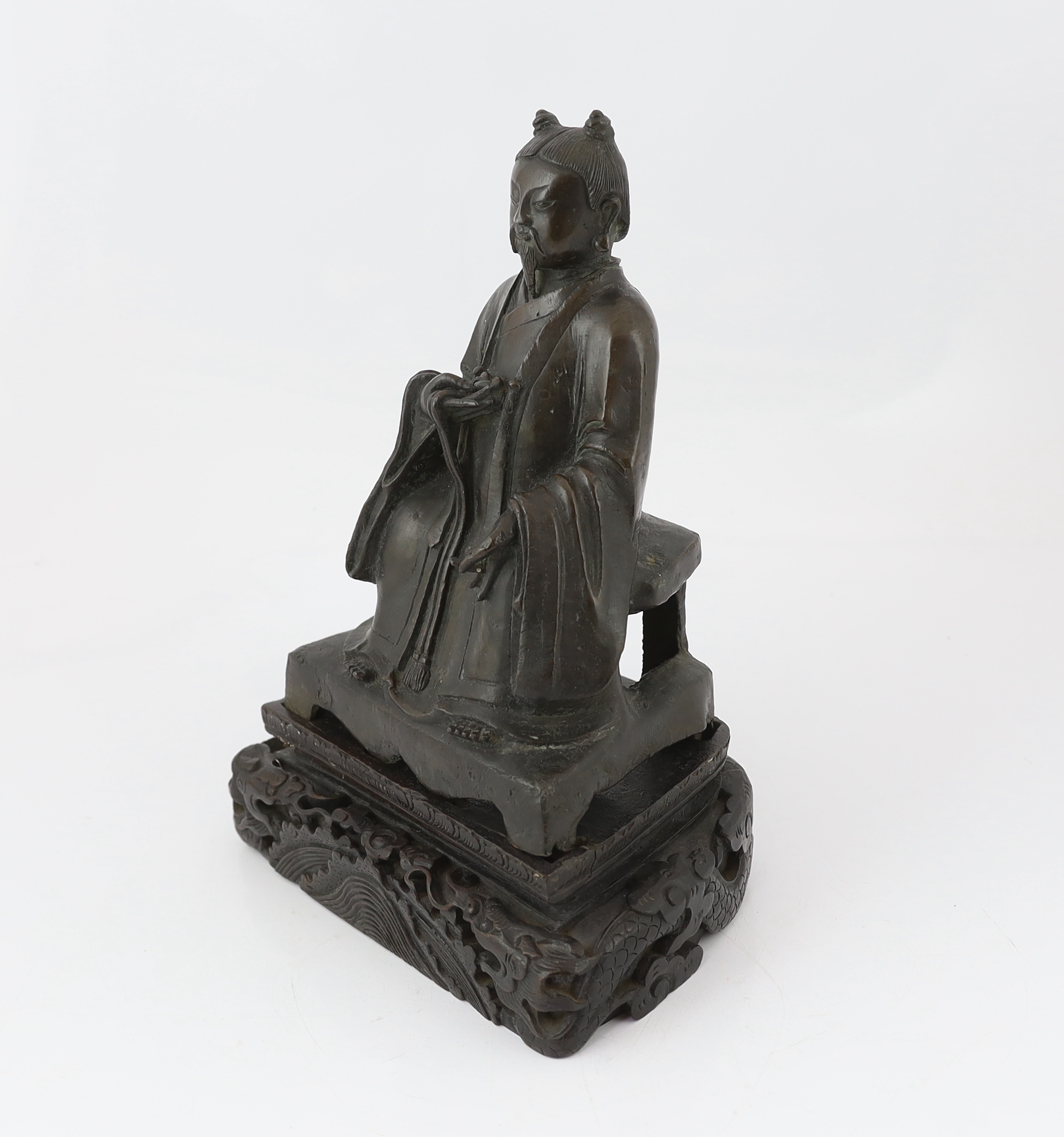 A Chinese bronze figure of a Daoist deity, late Ming, losses to back of throne